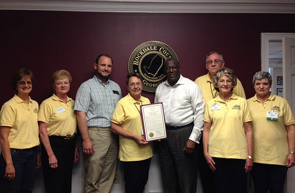 L to R: Marjean Levy, Treasurer; Jessie Brown, Corresponding Secretary; Steve Pettis, Rockdale County Extension Agent; Richard A. Oden, Chairman and CEO of the Rockdale County Board of Commissioners; Vivian Cheatham, President; Judy Abell, Board member; Jane Smith, Recording Secretary; back:  Ronnie Peden,  Board member.