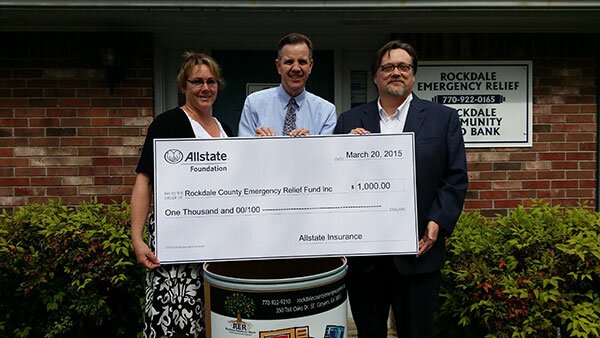 Left to right: Susan Clark, Food Bank Manager RER/ Allstate Agent Bob Foster / Andrew Peabody, Executive Director RER